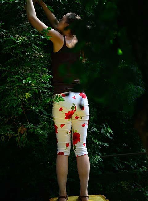 Claudia in white pants picking berries