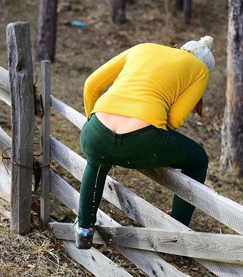 Straddling the fence pissing her pants